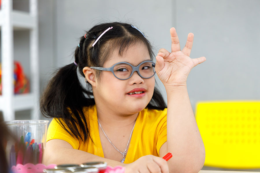 girl with Downs Syndrome looking at camera