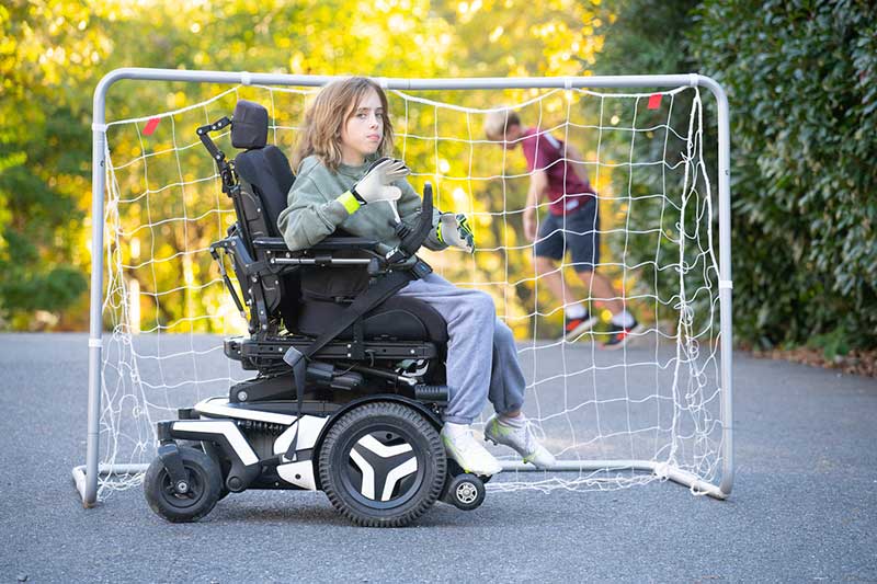 girl in wheelchair in front of net